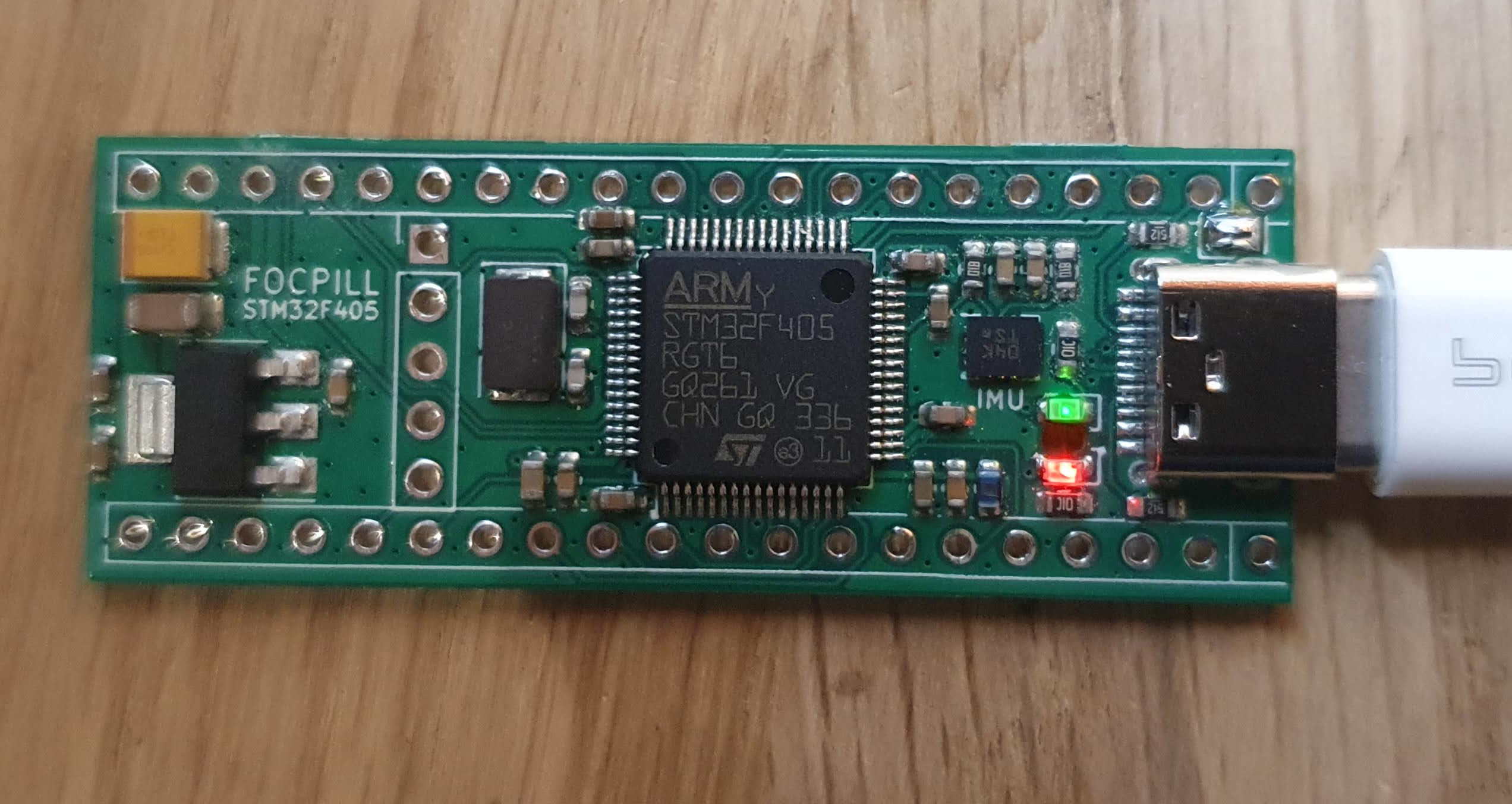 The FOCPILL STM32F405 control board with its USB-C connector, ARM STM32F405RGT6 microcontroller, onboard IMU, status LEDs, and 3.3 V regulator