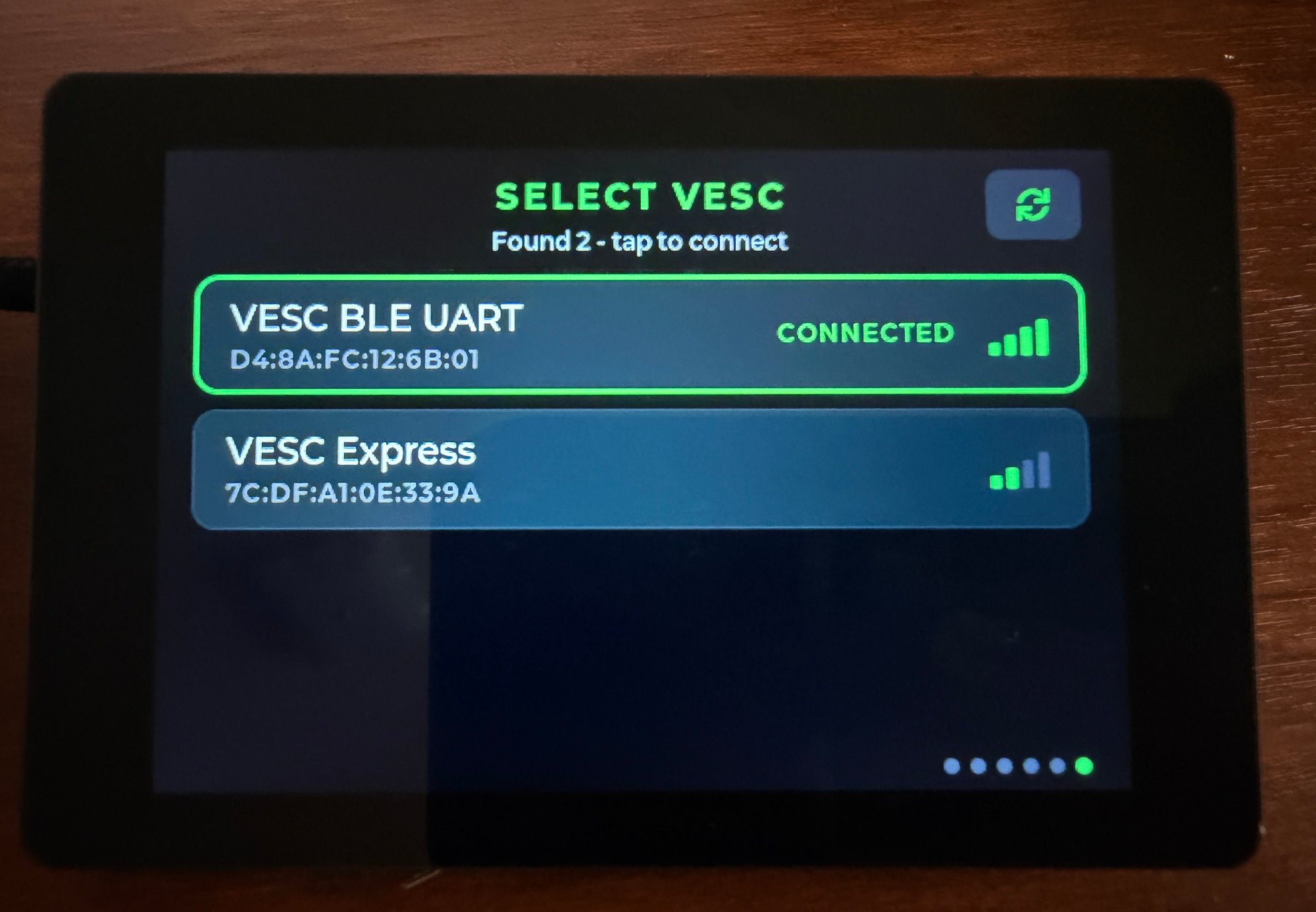 The Select VESC page listing two Bluetooth devices, VESC BLE UART outlined in green as connected with full signal bars and VESC Express below it, with a rescan button in the top corner